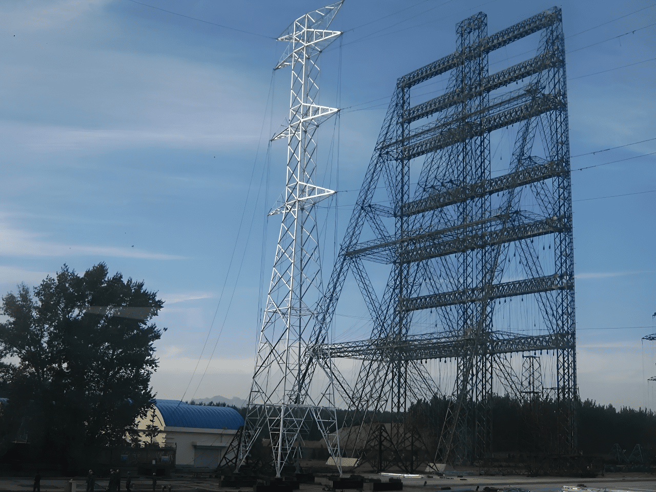 Large electrical transmission towers against blue sky