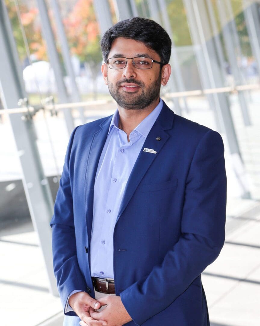 Man in blue suit smiling indoors