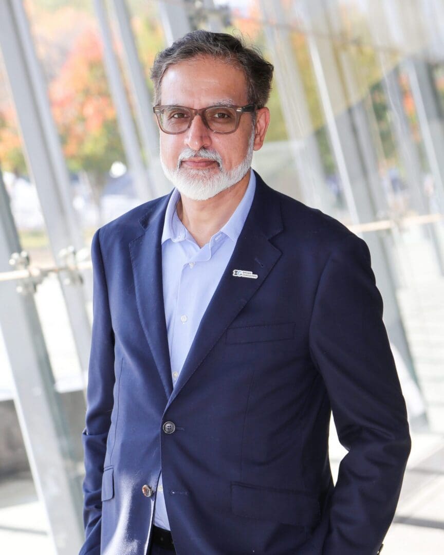 Bearded man in navy suit and glasses