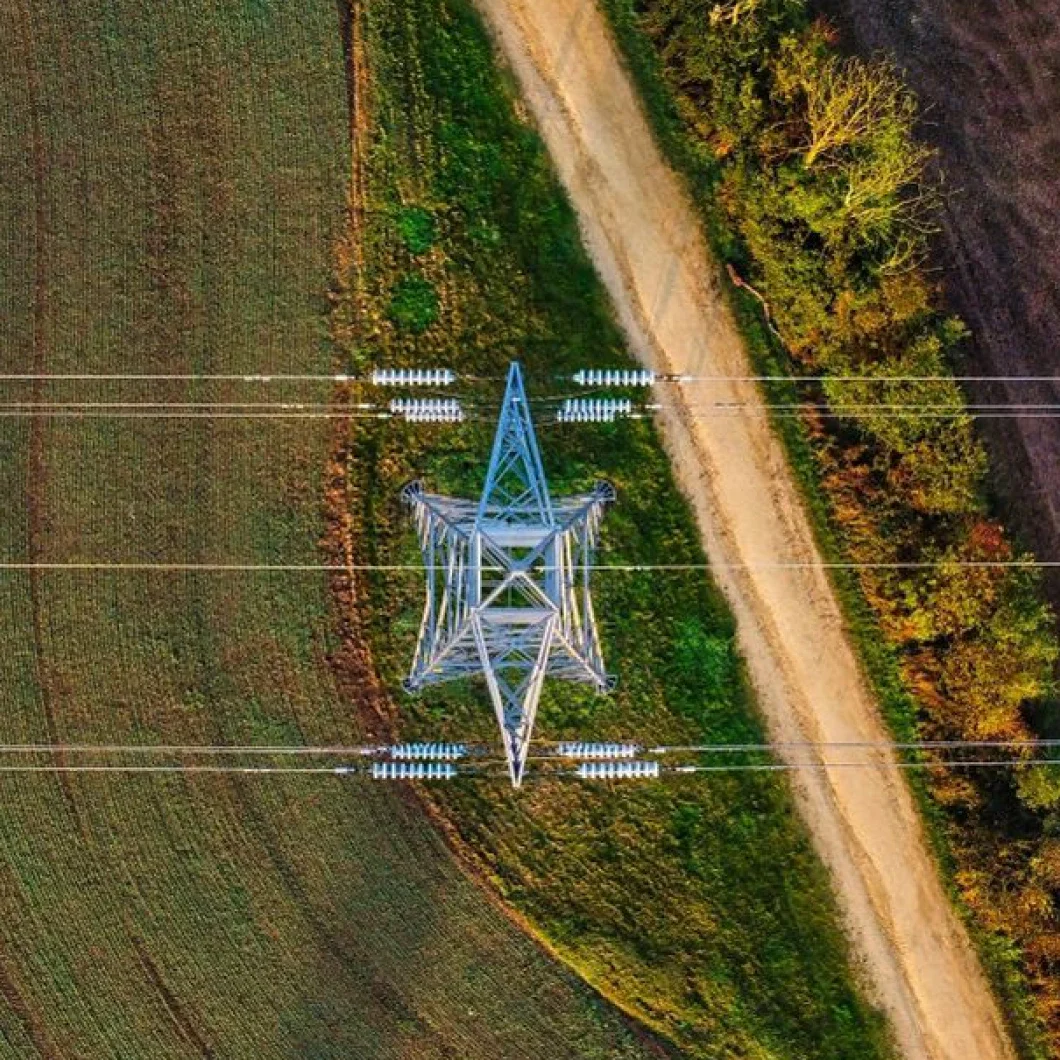 Transmission tower crossing rural landscape